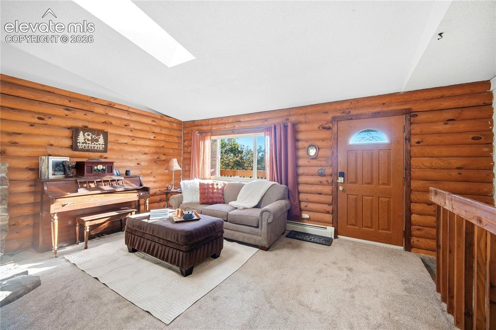 Image 4 of 34: Wood-paneled walls with log cabin construction