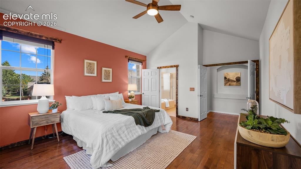 Image 13 of 43: Vaulted ceiling bedroom featuring wood-finish flooring, a ceiling fan, and 
