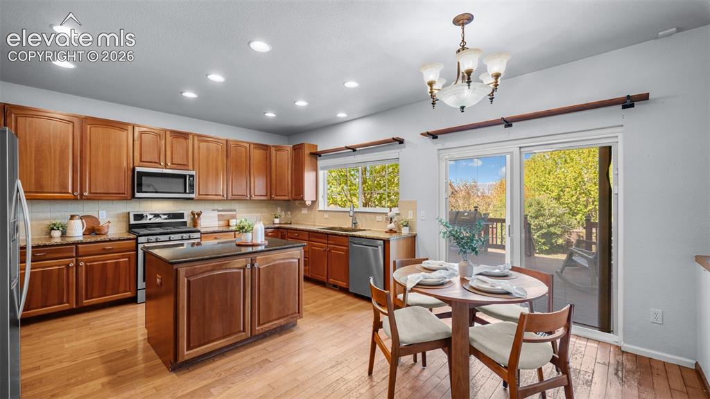 Image 17 of 43: Spacious kitchen featuring wood-finish flooring, abundant cabinetry, a cent