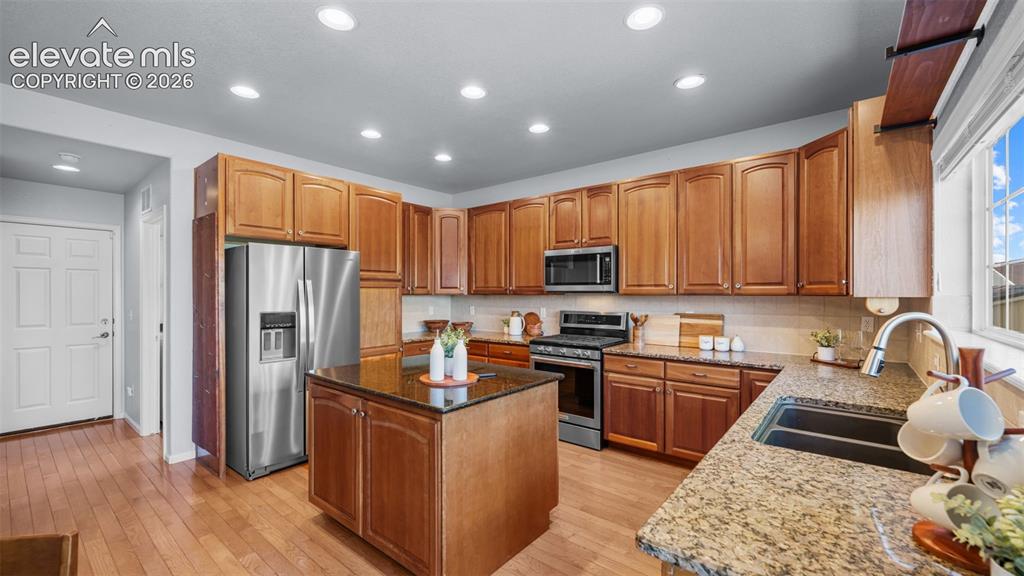 Image 18 of 43: Spacious kitchen featuring wood cabinetry, granite countertops, stainless s