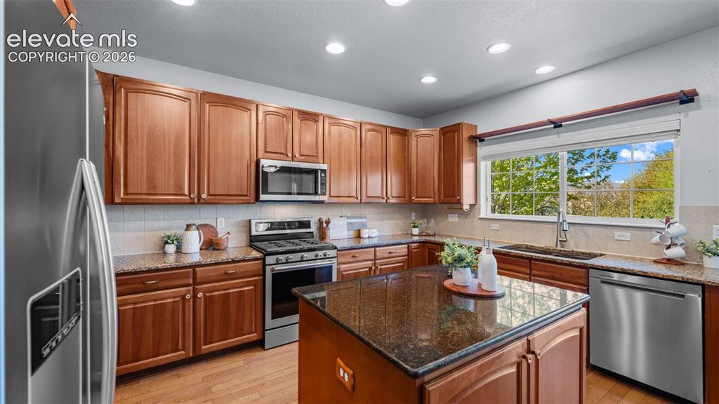 Image 19 of 43: Kitchen featuring wood cabinetry, granite countertops, stainless steel appl