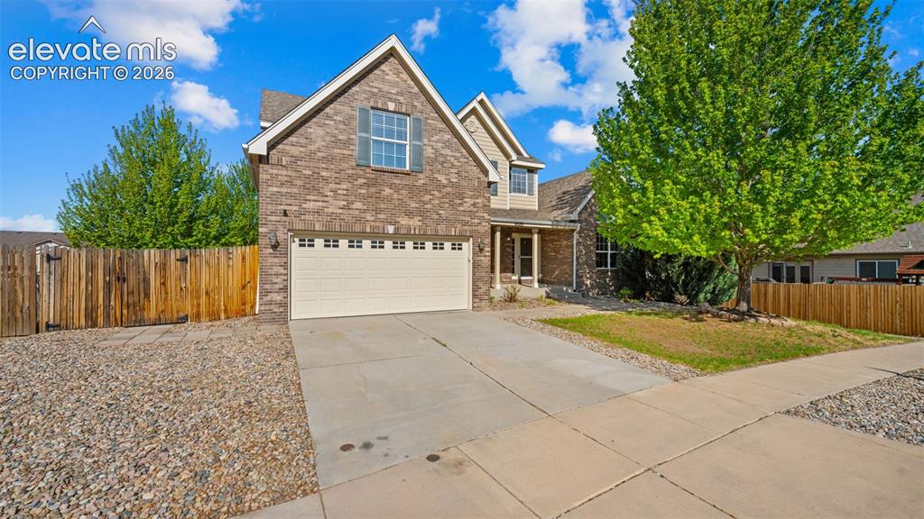 Image 2 of 43: Brick and siding exterior featuring an attached two-car garage, concrete dr