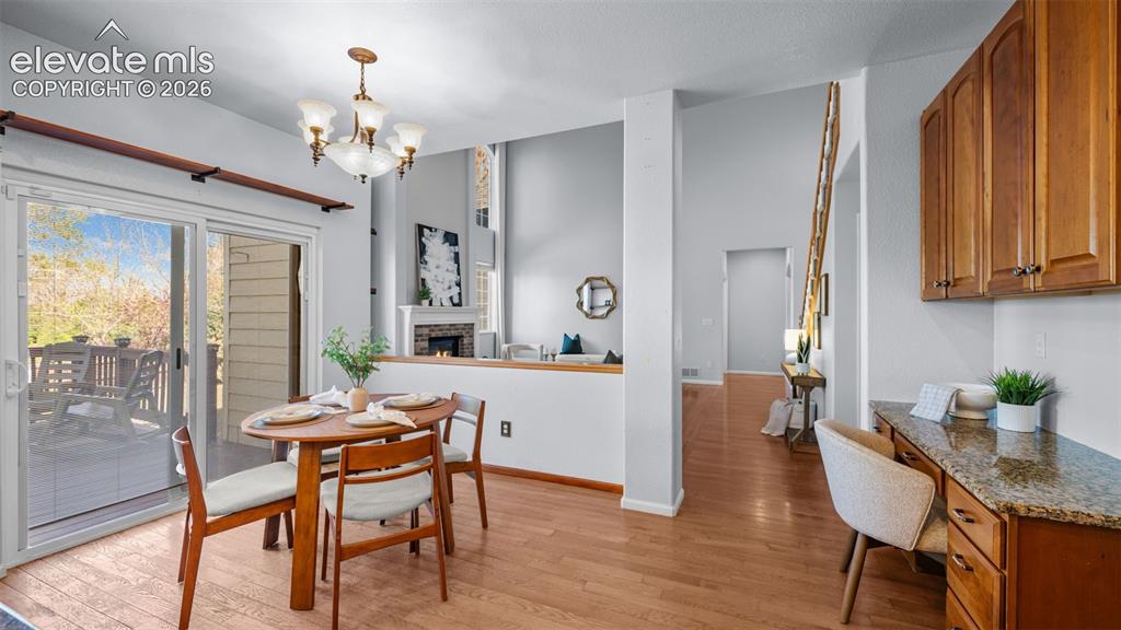 Image 20 of 43: Dining area featuring hardwood flooring, a brass and glass chandelier, and 