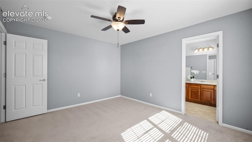 Image 22 of 43: Bedroom featuring neutral carpeting, light gray wall paint, and a ceiling f