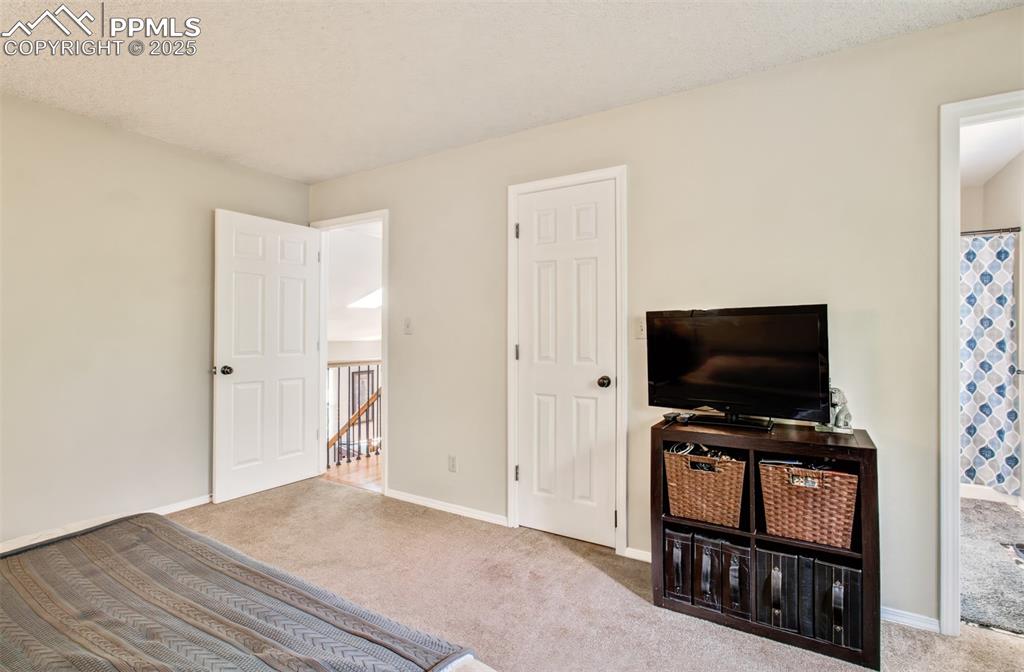 Image 16 of 25: Bedroom with carpet and baseboards