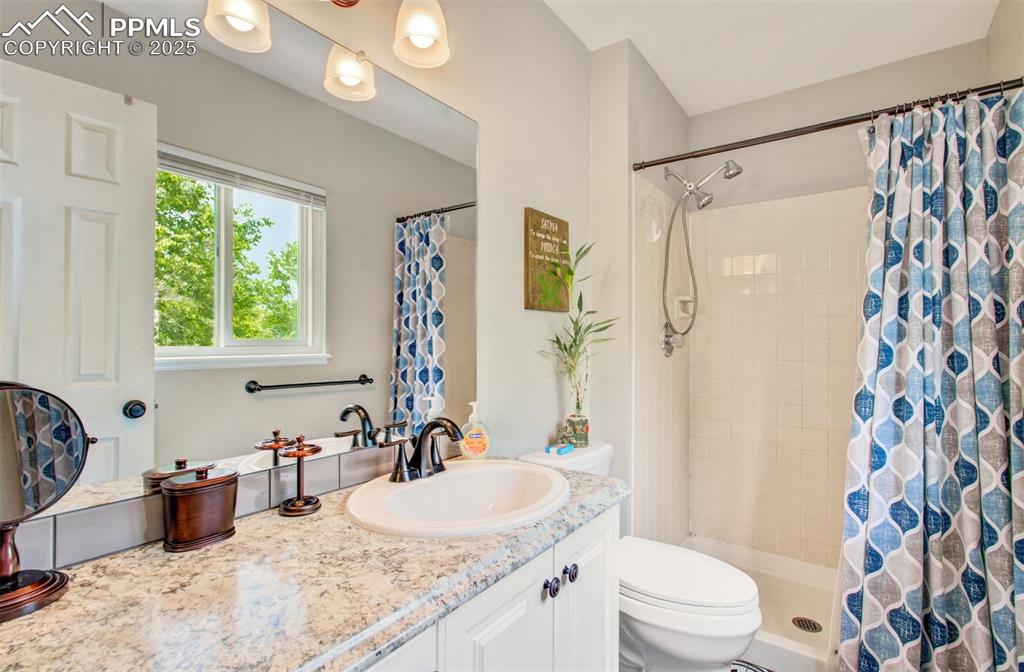 Image 17 of 25: Bathroom with vanity and a tile shower