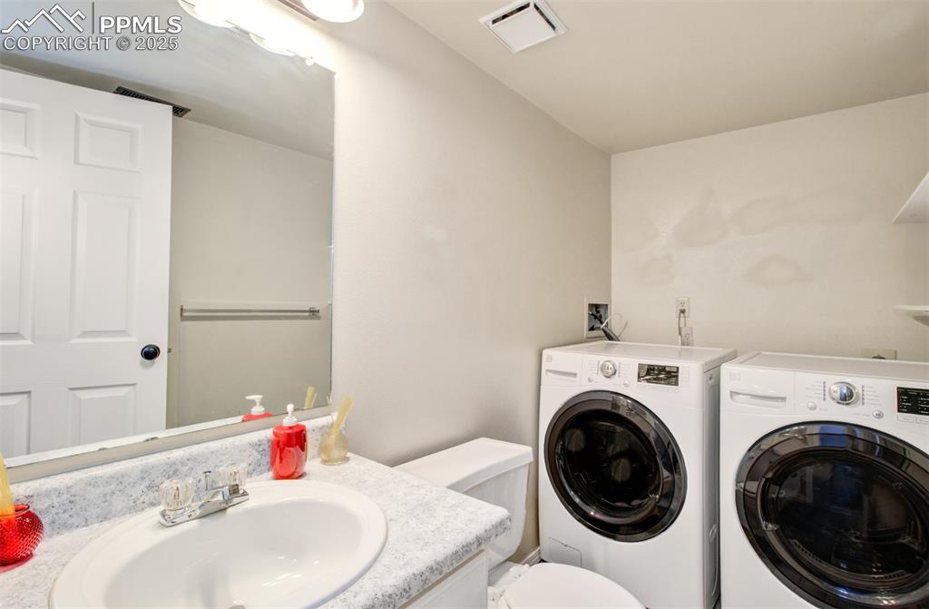 Image 19 of 25: Laundry area featuring washer and dryer