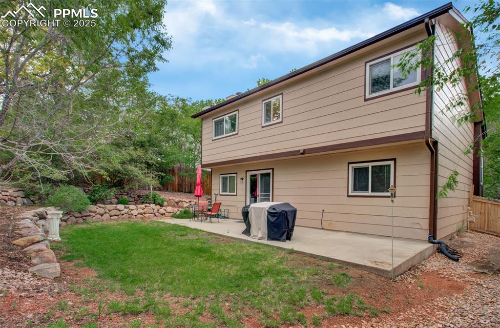 Image 2 of 25: Back of property with a patio area
