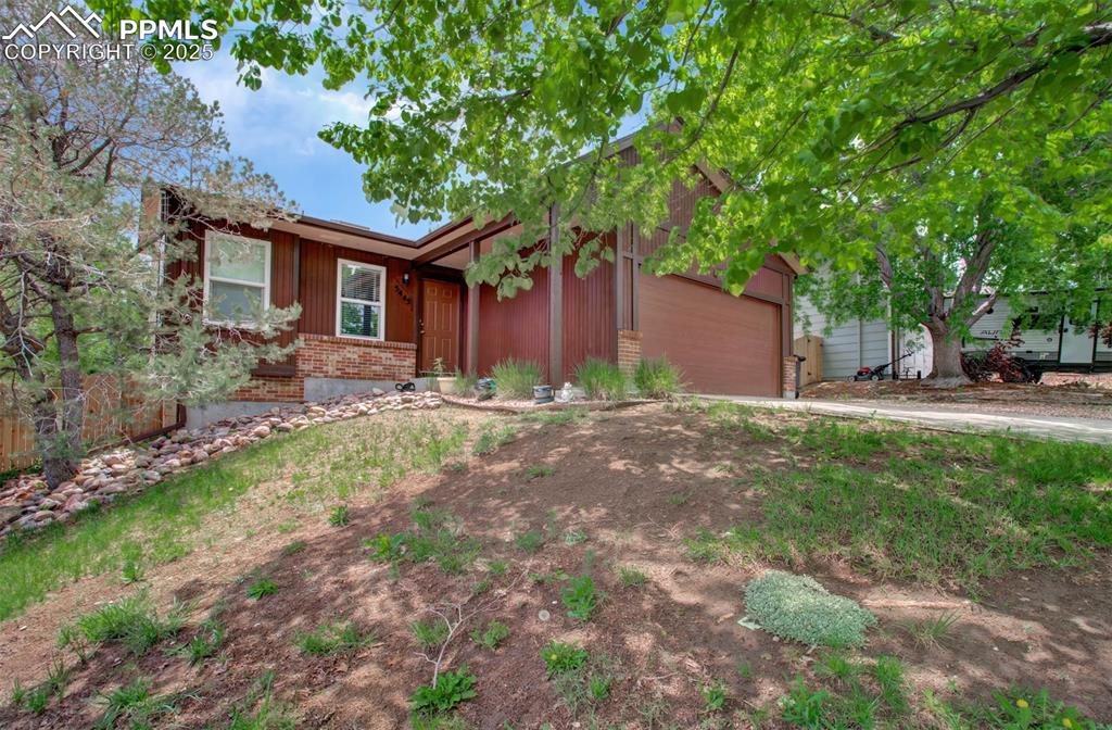 Image 25 of 25: Single story home with brick siding, an attached garage, and concrete drive