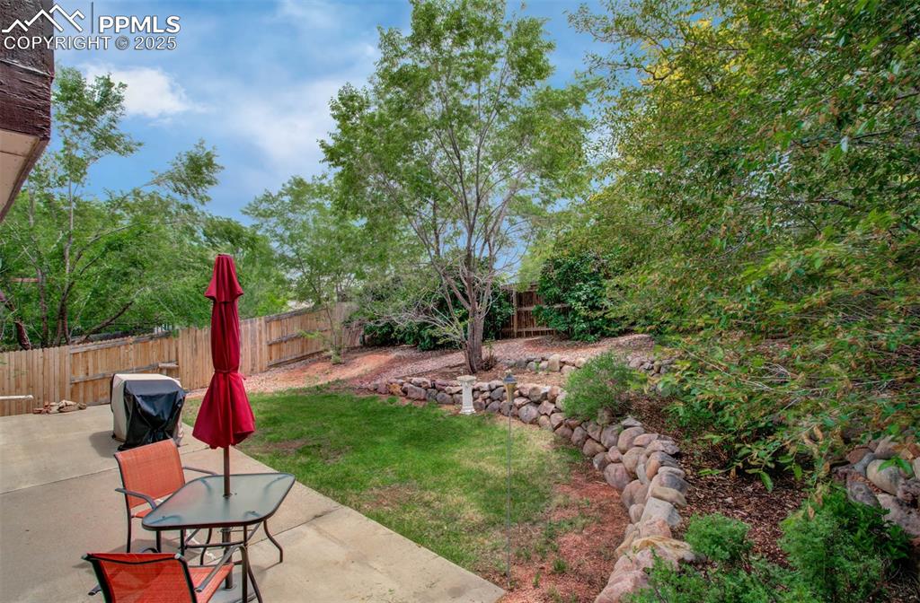 Image 3 of 25: Fenced backyard featuring a patio