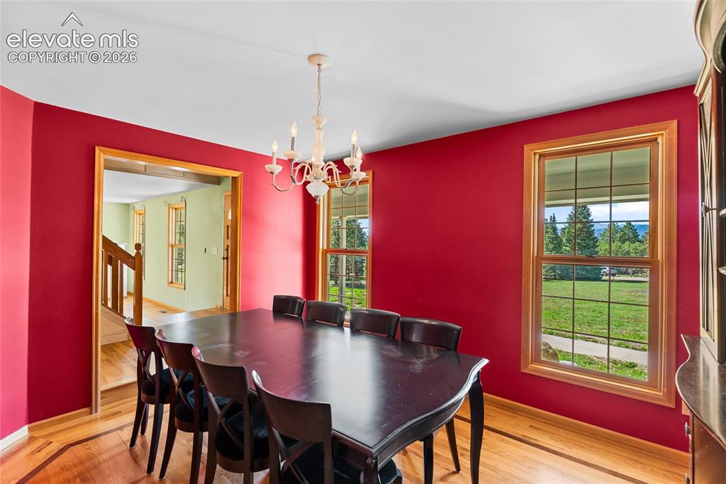Image 10 of 49: Recessed ceiling with an ornate chandelier, multiple large windows, and woo