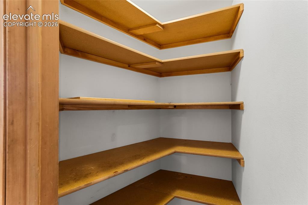 Image 15 of 49: Built-in shelving units with light wood-finish and white painted walls