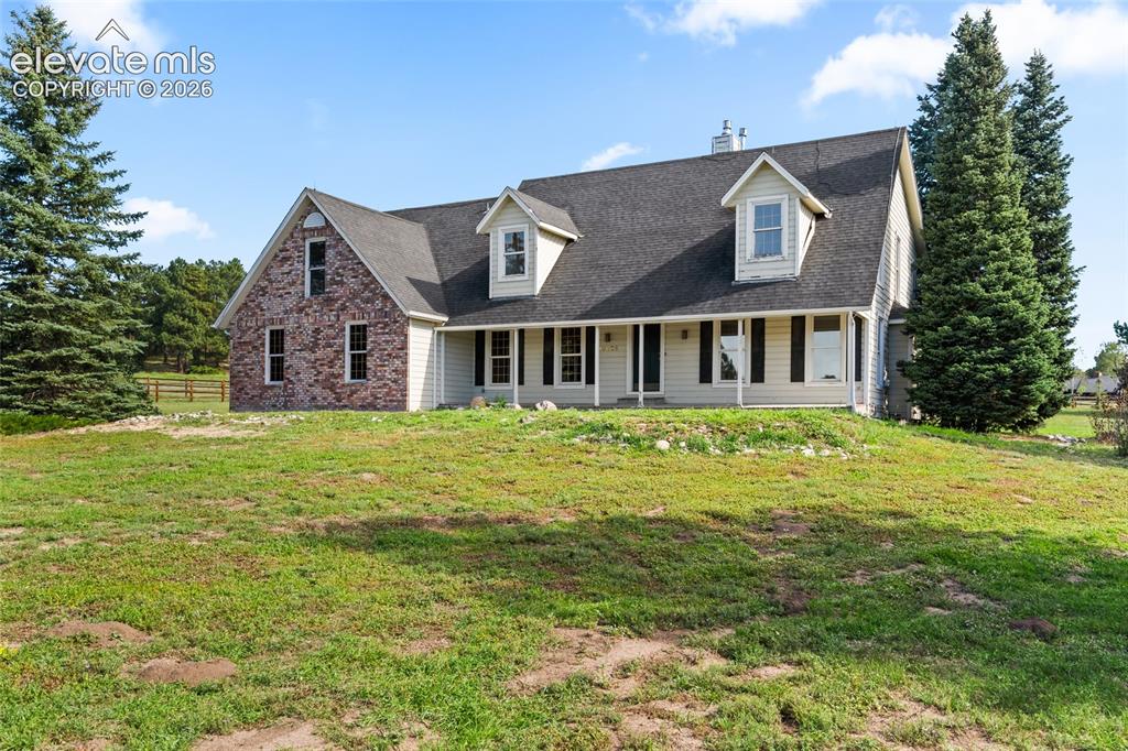 Image 3 of 49: Two-story home featuring a combination brick and siding exterior, dark shin