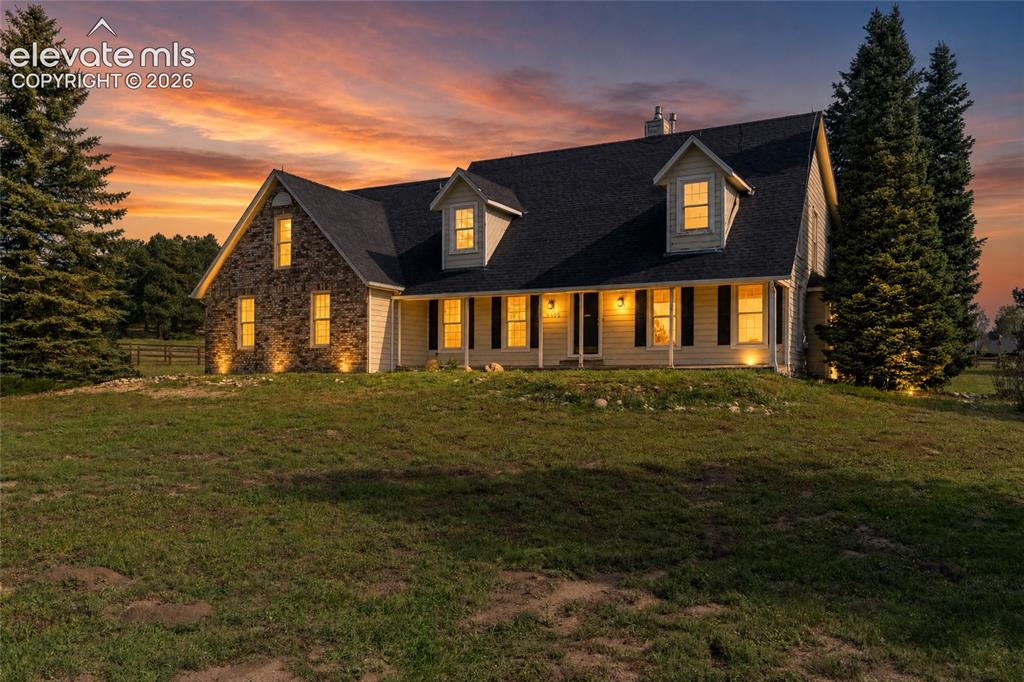 Image 47 of 49: Crafted home exterior featuring brick and siding finishes, a dark shingle r