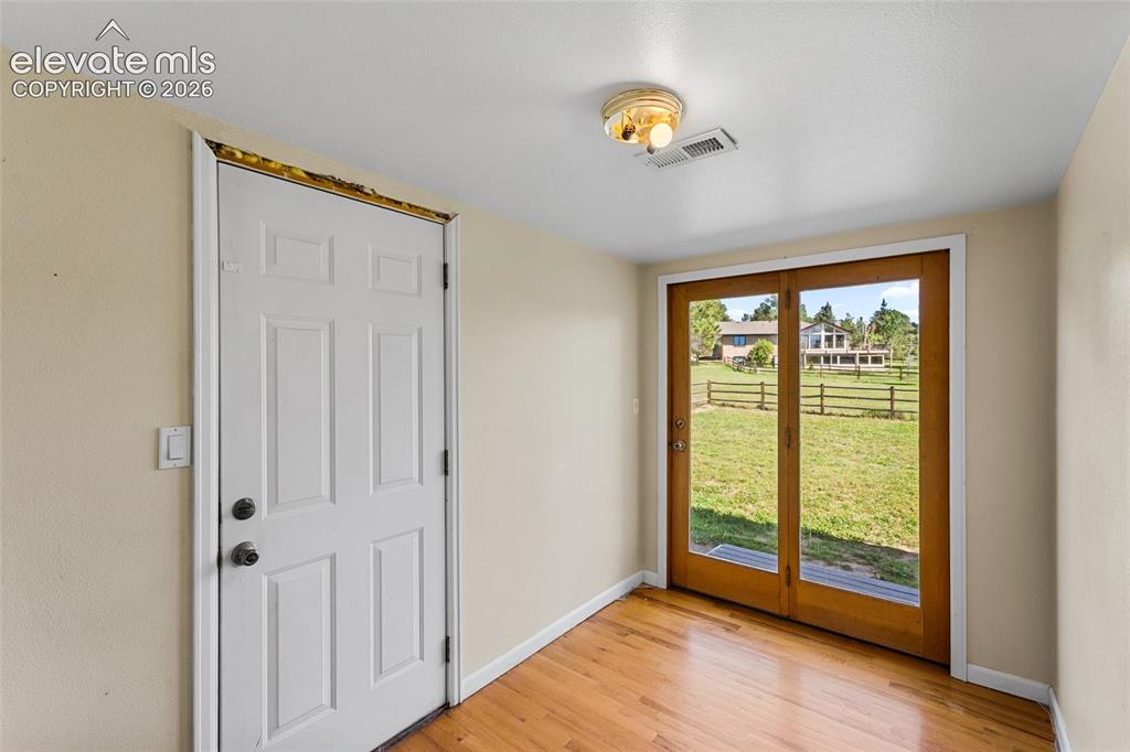 Image 48 of 49: Hardwood flooring, painted interior walls, flush mount ceiling fixture, pan