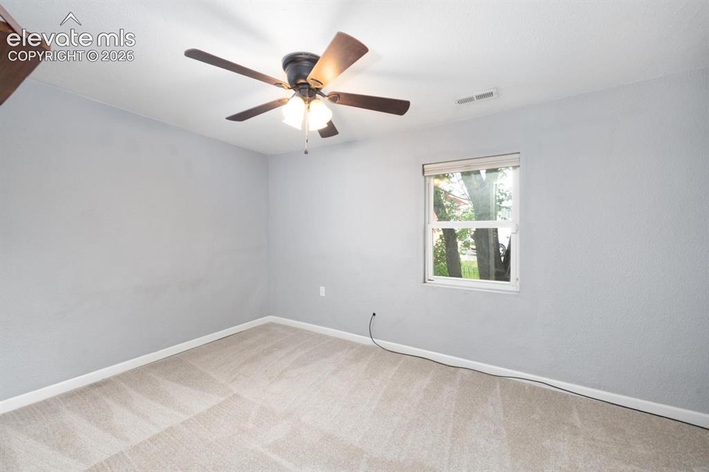 Image 10 of 30: The second main level bedroom