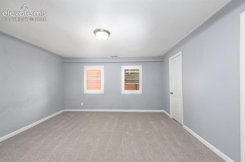 Image 6 of 30: Main level en-suite with 3/4 bathroom and walk-in closet