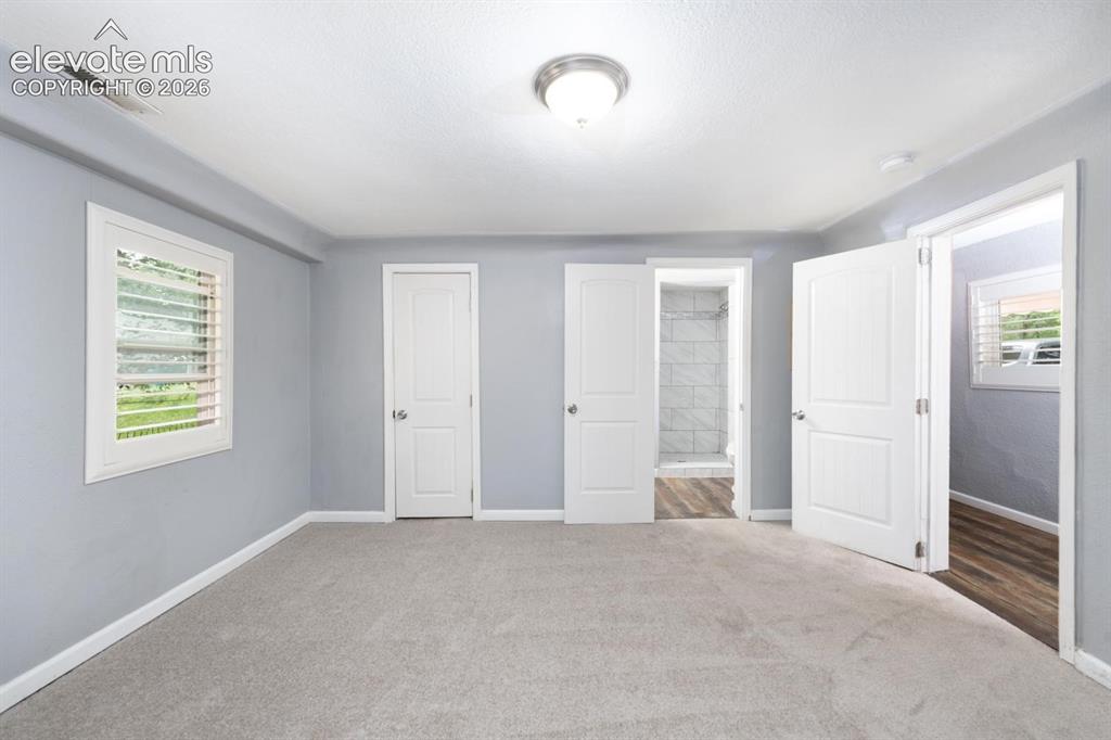Image 7 of 30: Main level en-suite with 3/4 bathroom and walk-in closet