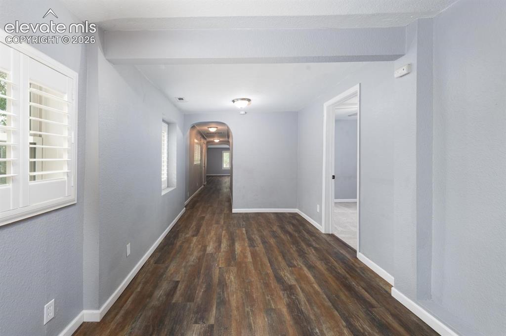 Image 9 of 30: Hallway and dining area connecting the living room to the kitchen