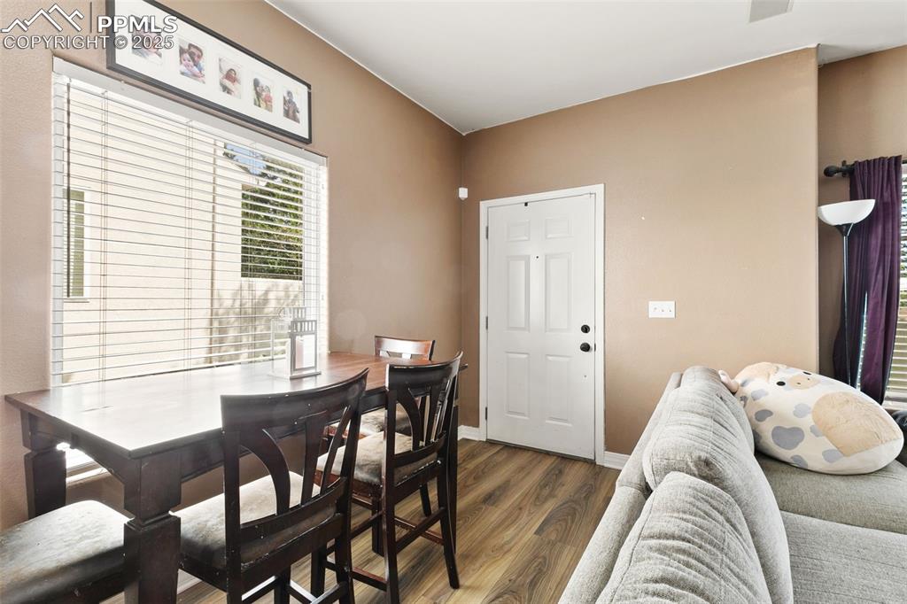 Image 11 of 29: Dining room featuring wood finished floors and baseboards