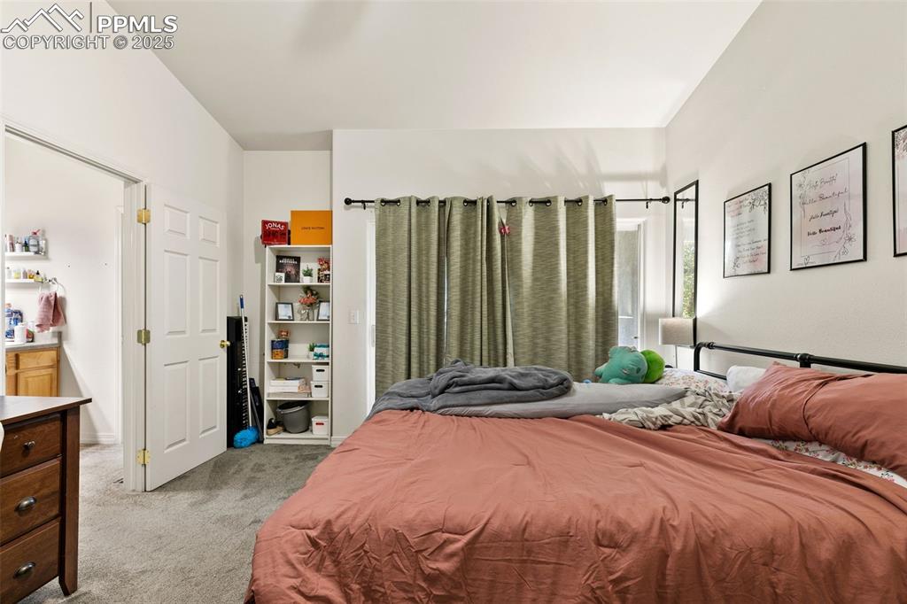 Image 17 of 29: Bedroom featuring light carpet