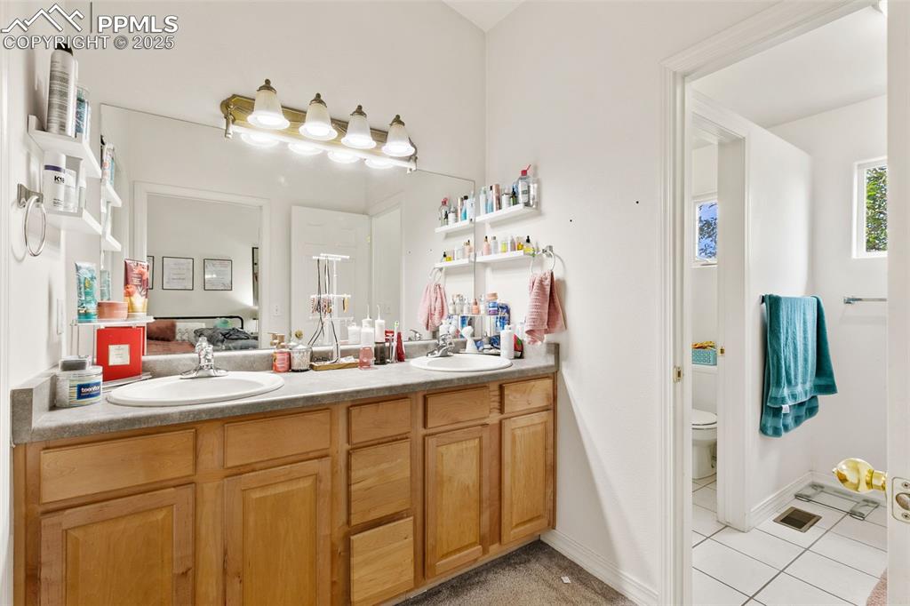 Image 19 of 29: Full bathroom featuring light tile patterned flooring and double vanity