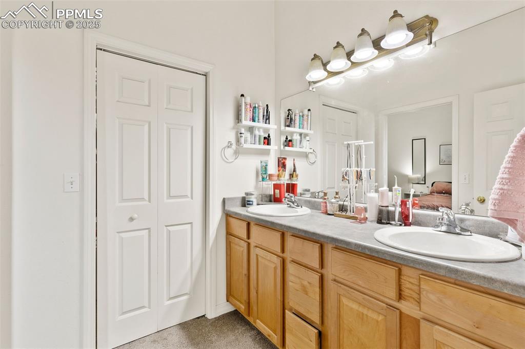 Image 21 of 29: Full bathroom featuring a closet, ensuite bathroom, and double vanity