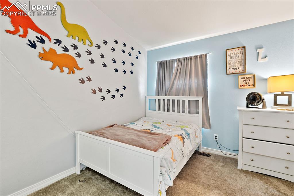 Image 24 of 29: Bedroom with carpet flooring and baseboards