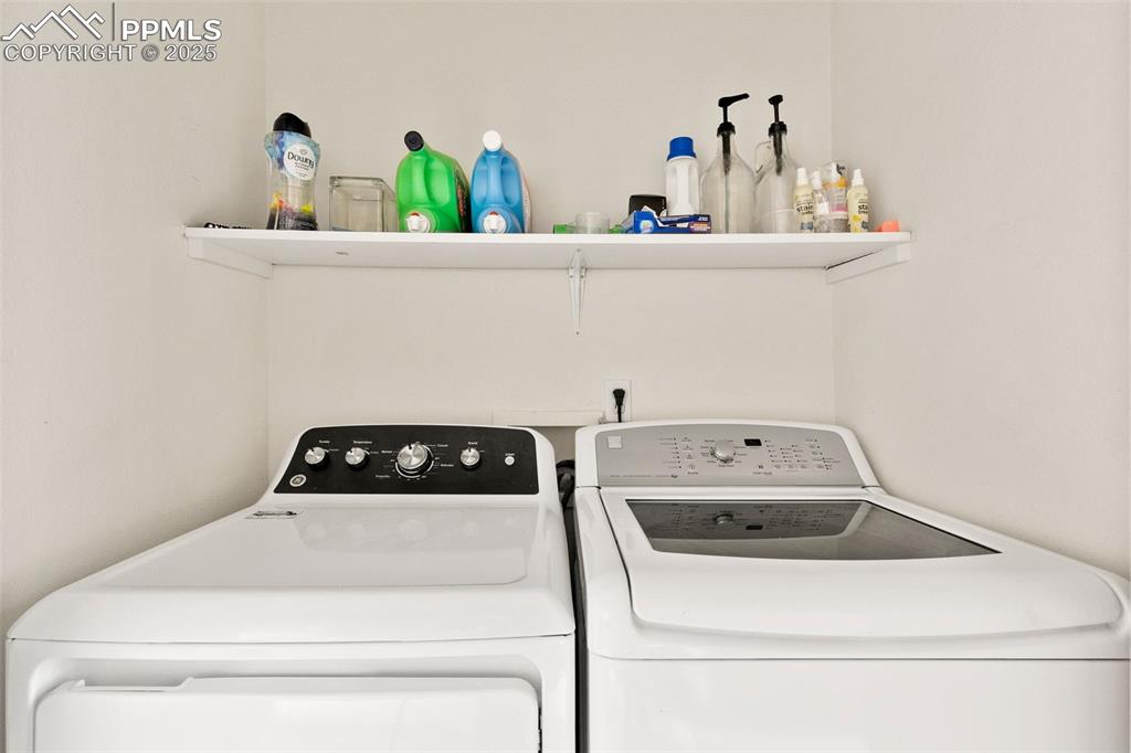 Image 28 of 29: Washroom featuring independent washer and dryer