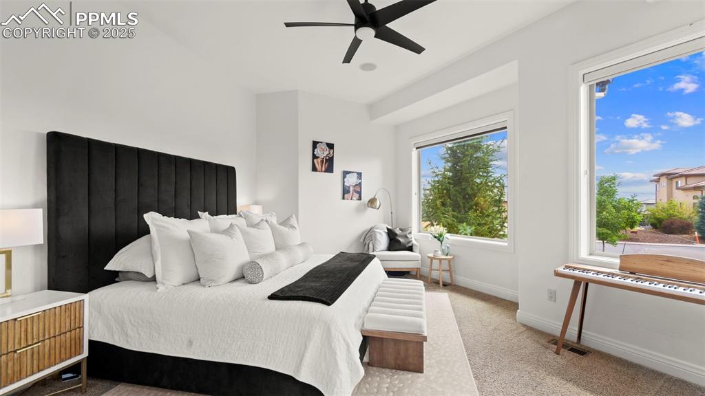 Image 18 of 50: Bedroom featuring light carpet and ceiling fan