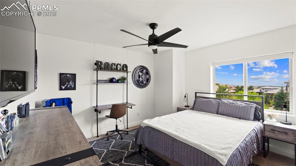 Image 35 of 50: Bedroom with a ceiling fan and baseboards