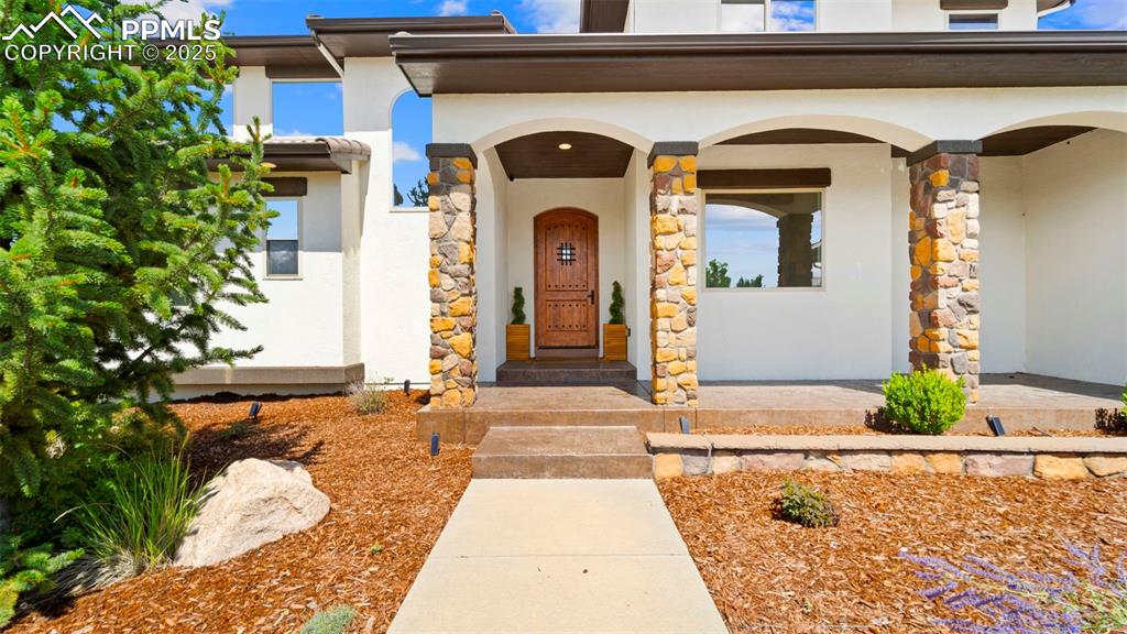 Image 4 of 50: Entrance to property featuring stucco siding