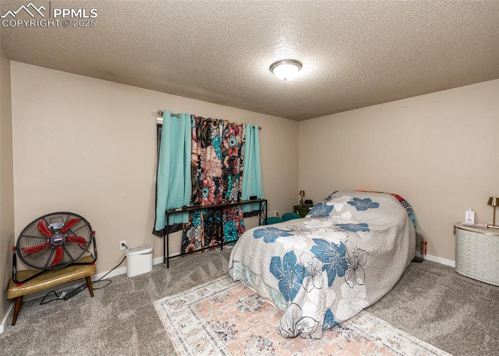 Image 23 of 42: Carpeted bedroom featuring a textured ceiling