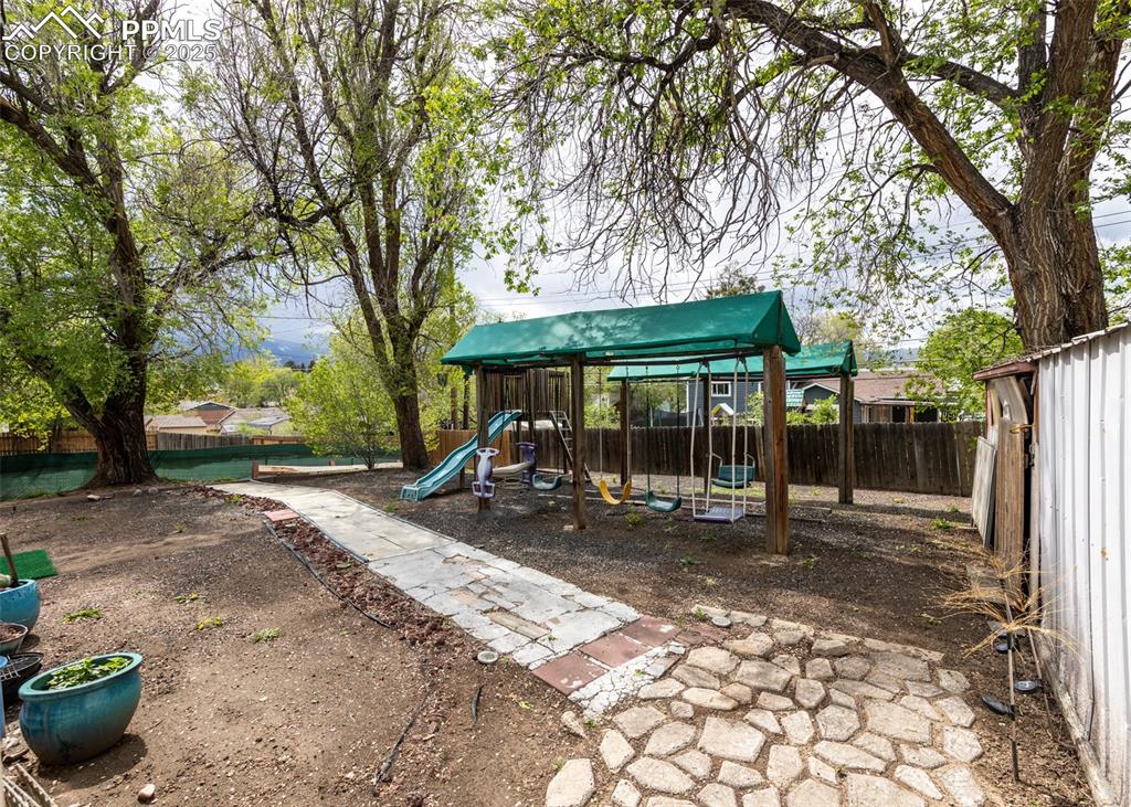 Image 40 of 42: View of jungle gym with fence
