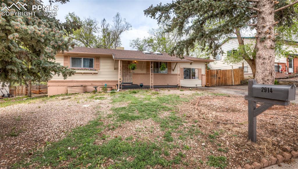 Image 42 of 42: Ranch-style home with fence and a gate
