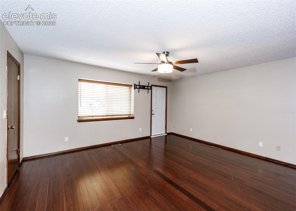 Image 14 of 32: primary bedroom with access to the wrap around deck.