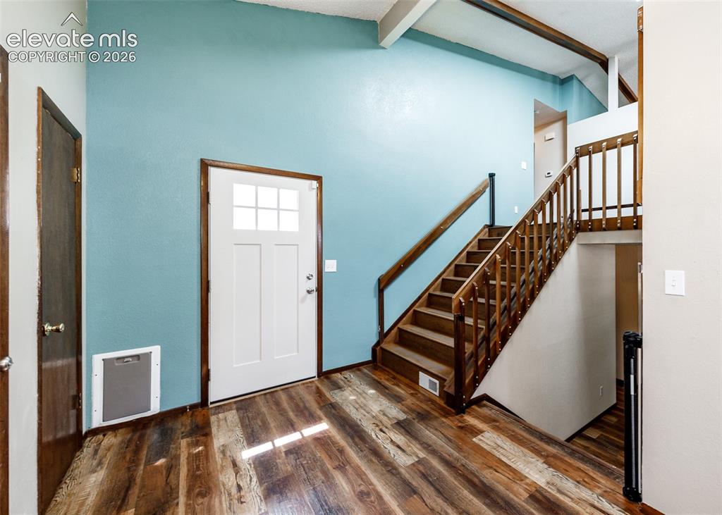 Image 4 of 32: Open Foyer with garage and backyard access.