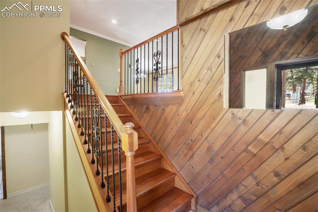Image 16 of 36: Stairs with custom rails and balusters from entry to main level