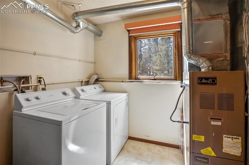 Image 27 of 36: Laundry room and mechanicals in lower level