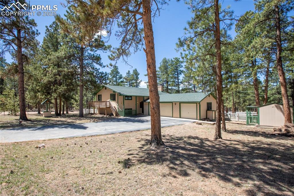 Image 36 of 36: View of front of property with fence, an attached garage, and concrete driv