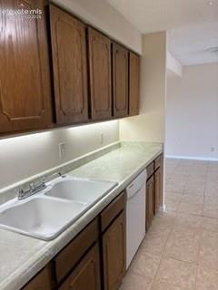Image 3 of 24: Tiled floors and wood cabinets