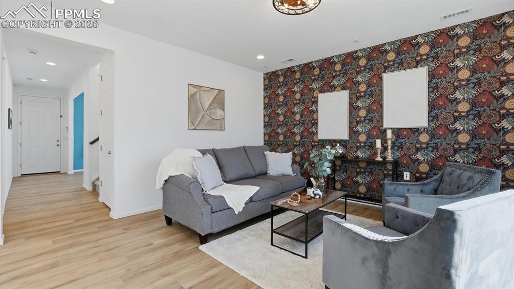 Image 10 of 45: Great Room with ceiling fan and LVP flooring.