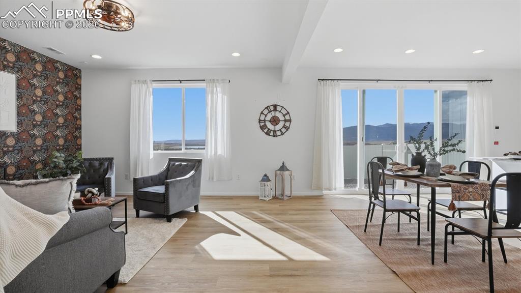 Image 12 of 45: The Great Room flows seamlessly into the Dining Area and overlooks the back