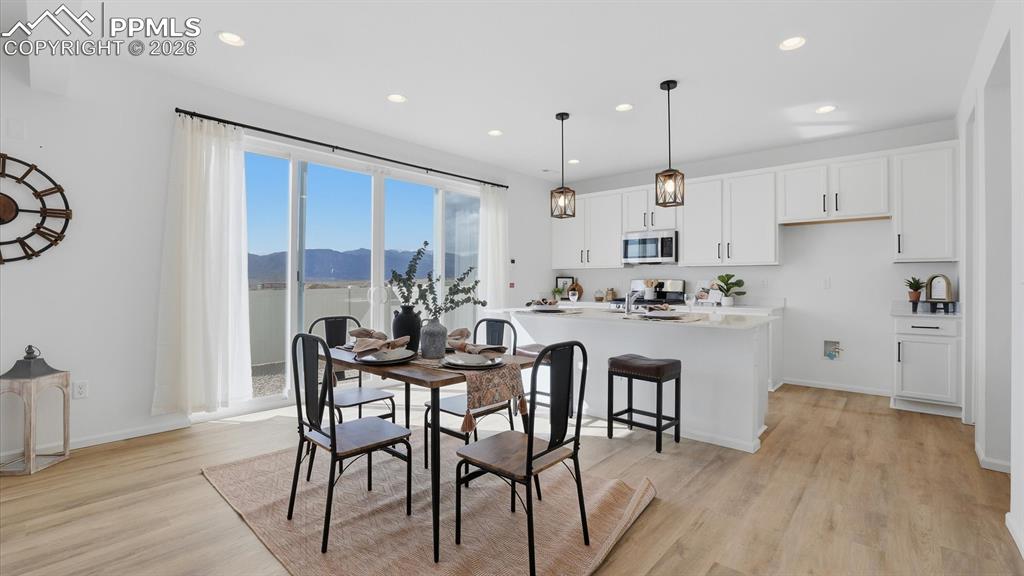 Image 14 of 45: The Dining Area has a slider to the fenced backyard.