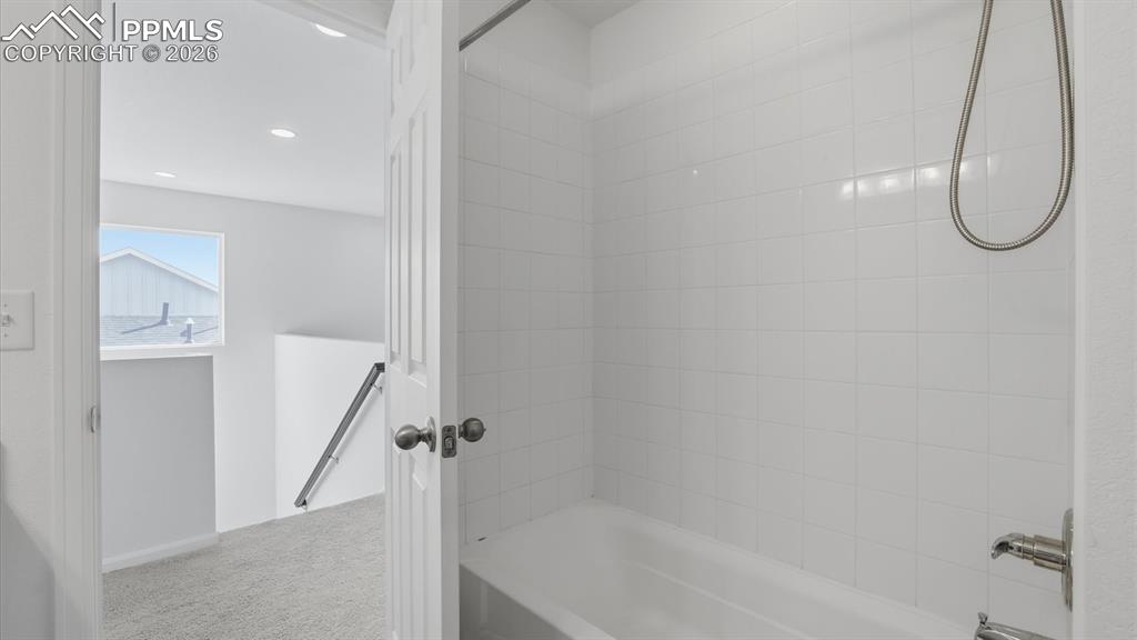 Image 21 of 45: Stairs to the upper level and entrance into the Full Bathroom.