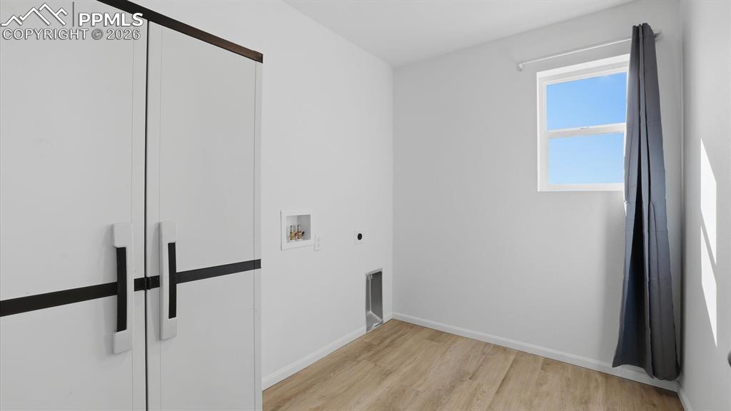 Image 26 of 45: Upper Level Laundry Room with built-in cabinets, electrical hook up, and a 