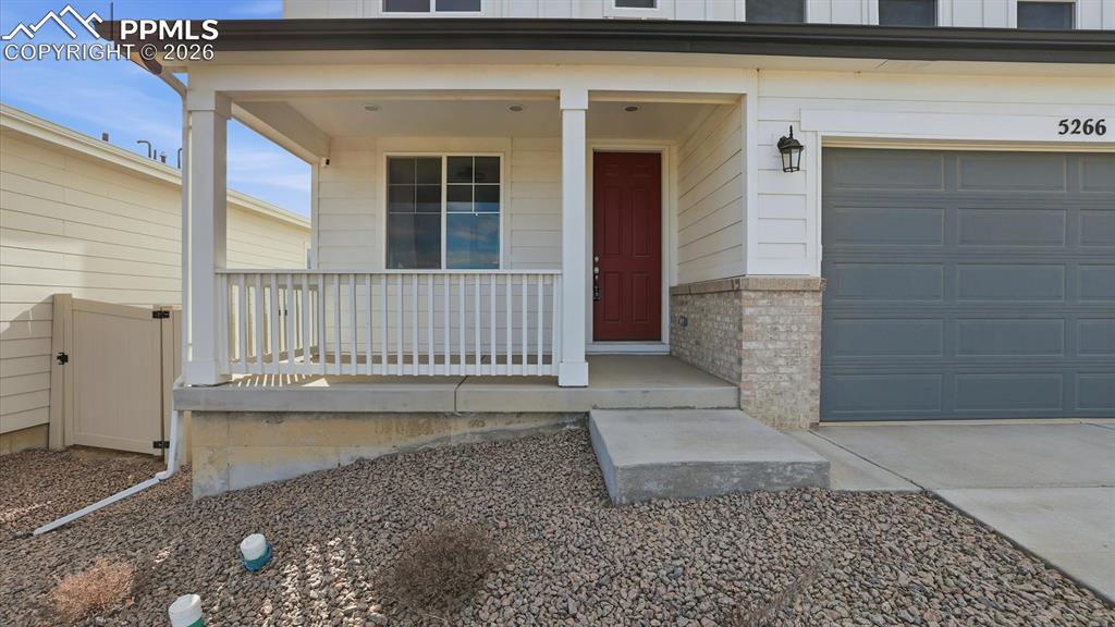 Image 3 of 45: Covered front porch to enjoy the Colorado sunshine.