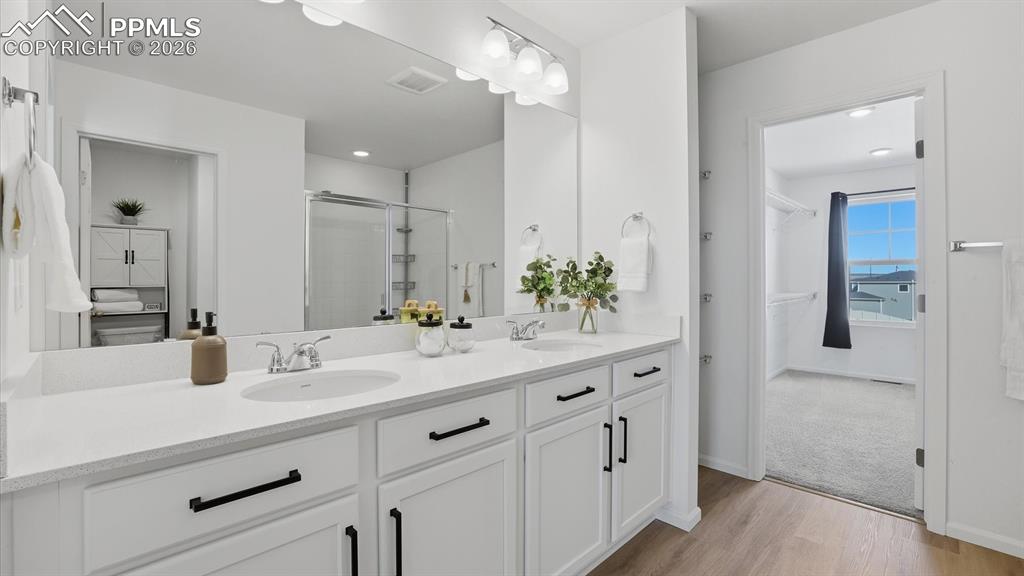 Image 31 of 45: Primary Bathroom with double sink vanity and mirror.