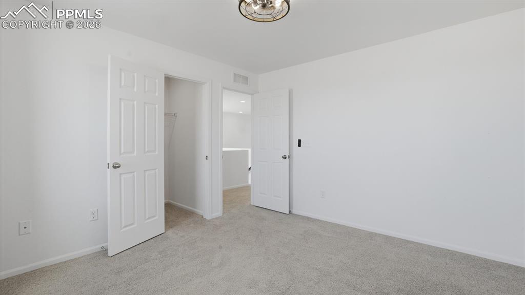 Image 35 of 45: Upper Level Bedroom #2 with walk in closet.