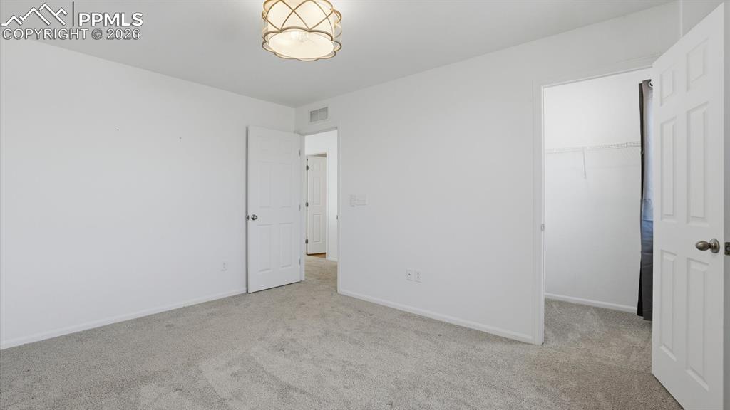 Image 37 of 45: Upper level Bedroom #3 with walk in closet.